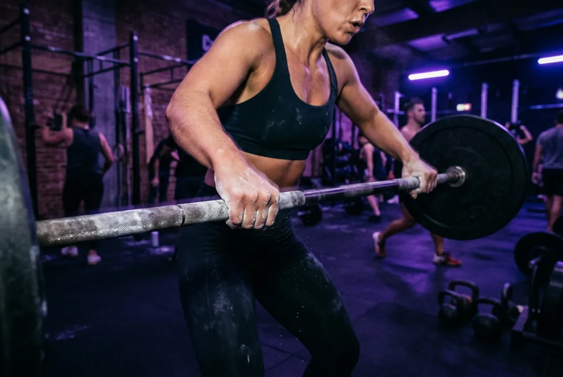 chalked hands gripping a barbell